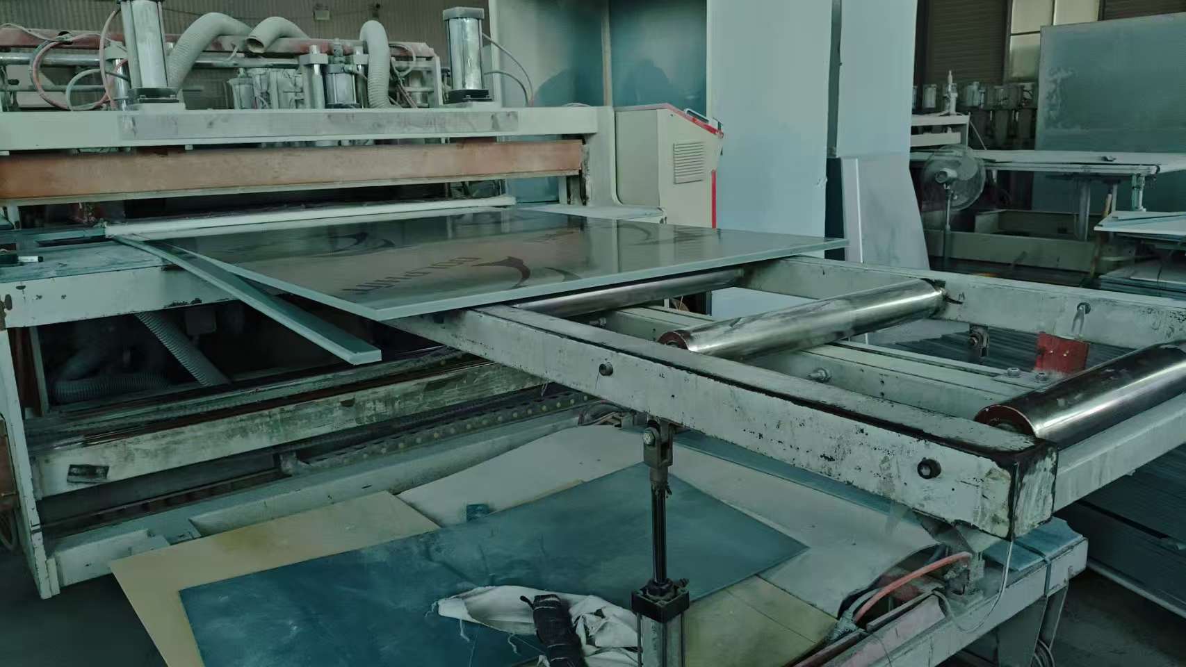 PVC extrusion line with metal rollers forming continuous panel sheet
