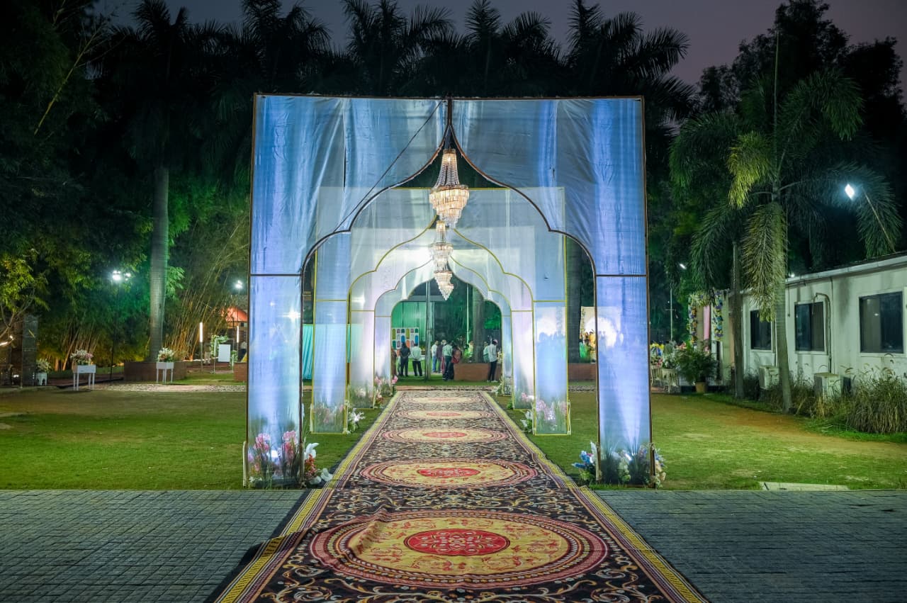 Wedding Lawn in Nashik – Night event with illuminated arch and chandelier at Vrindavan Greens