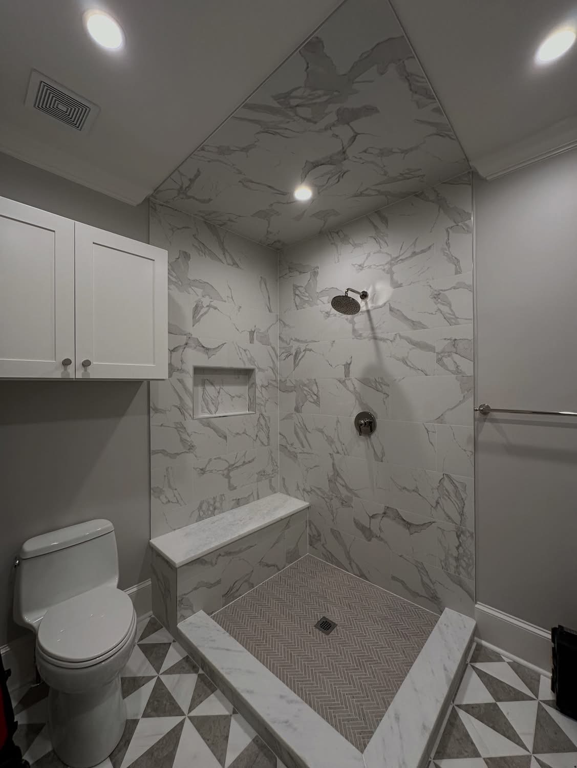 Marble shower with bench and rain head