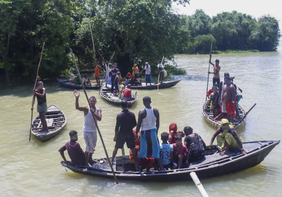 Boats carrying villagers across flooded plains in Bihar