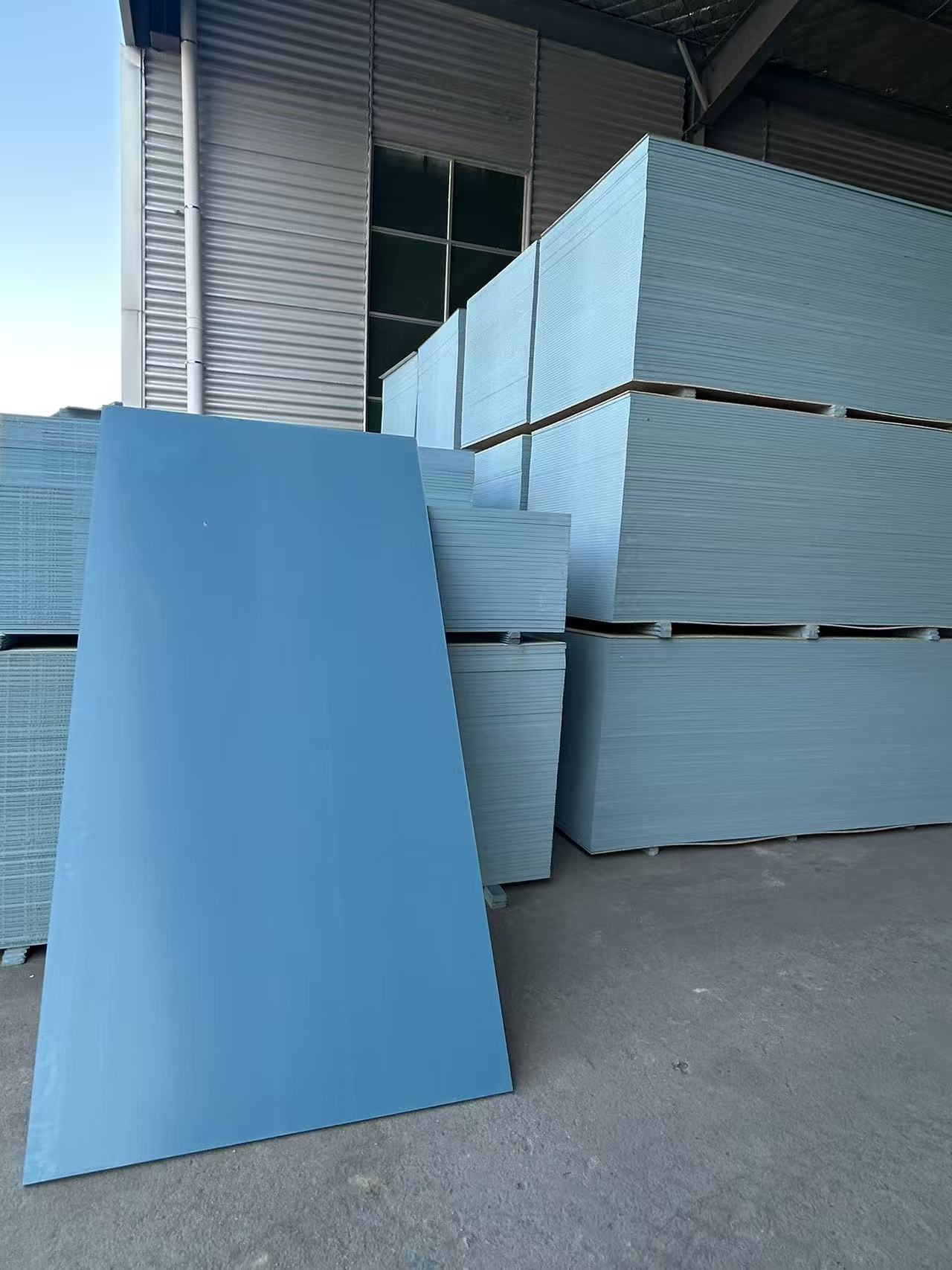 PVC formwork panels stacked on wooden dunnage pallets