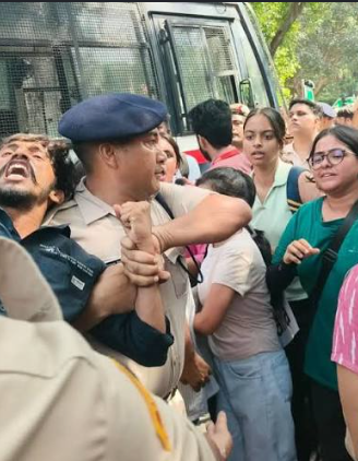 Crowd surrounding policeman