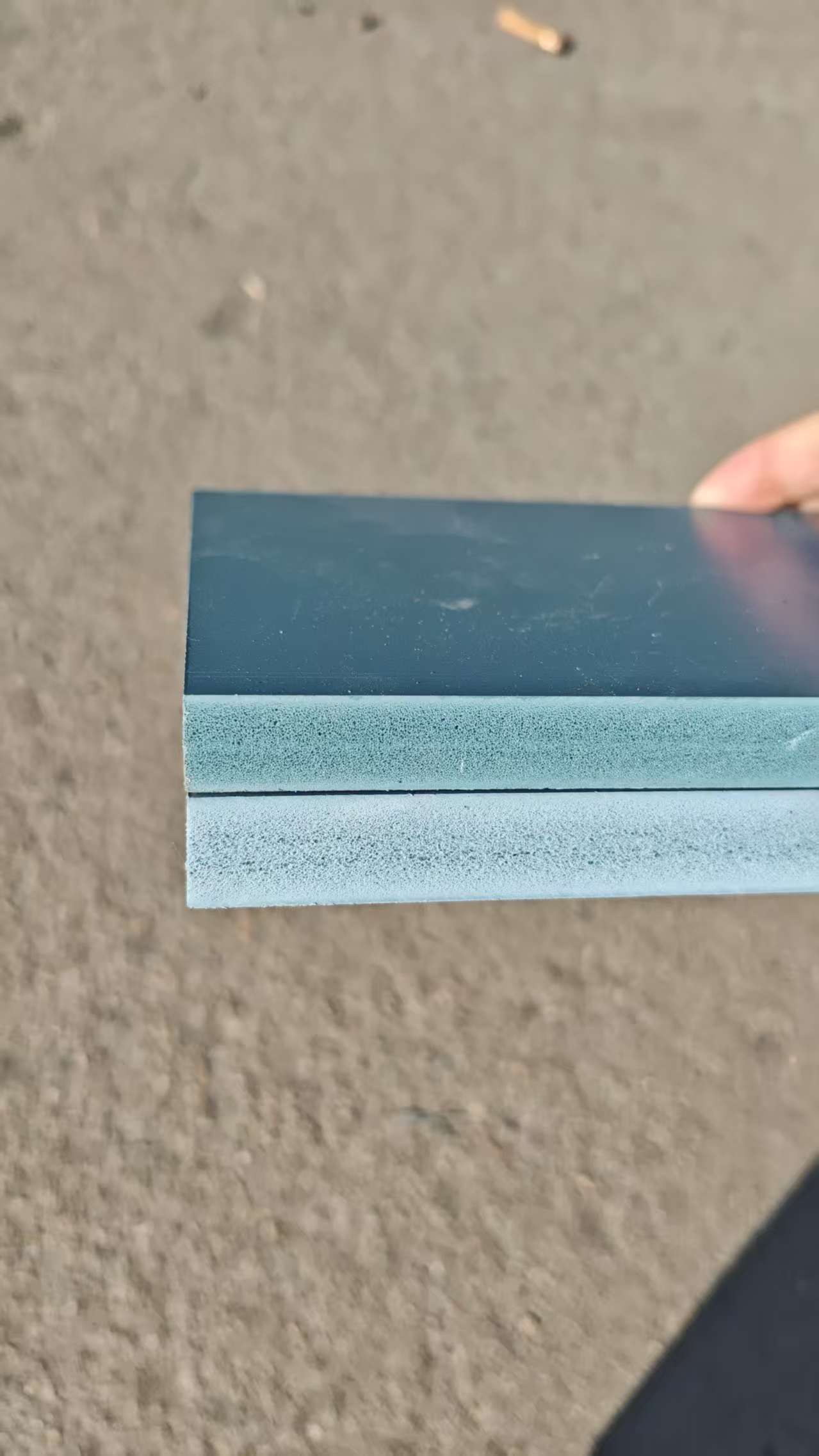 Close-up of PVC beam formwork panel showing ribbed texture surface and color gradient