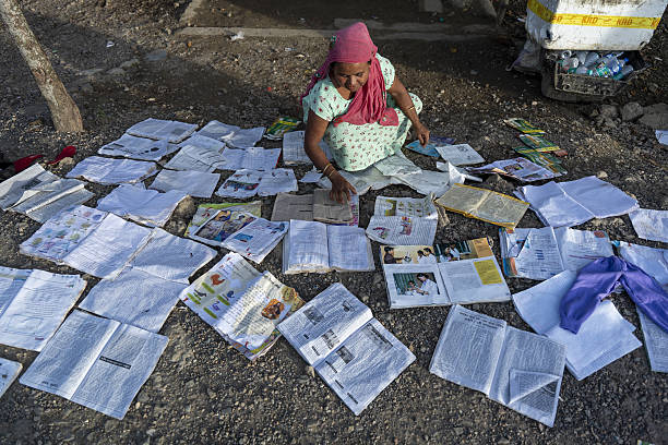 Woman collecting destroyed belongings