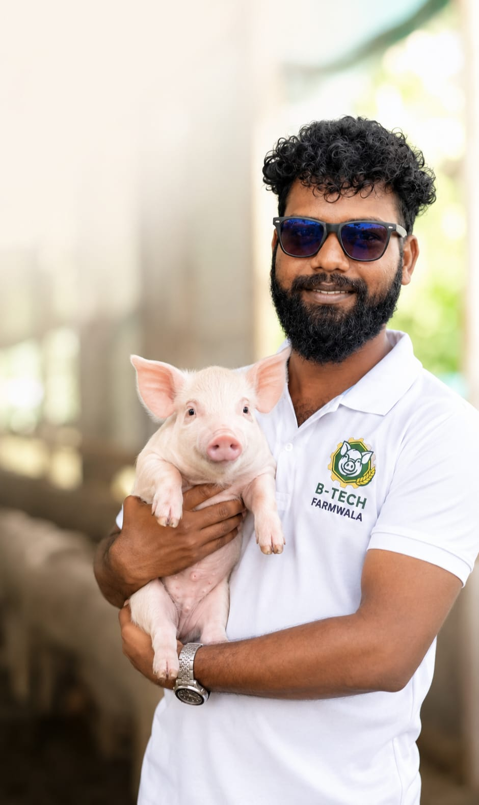 Chirgal Tudu, Founder & Director holding a baby pig