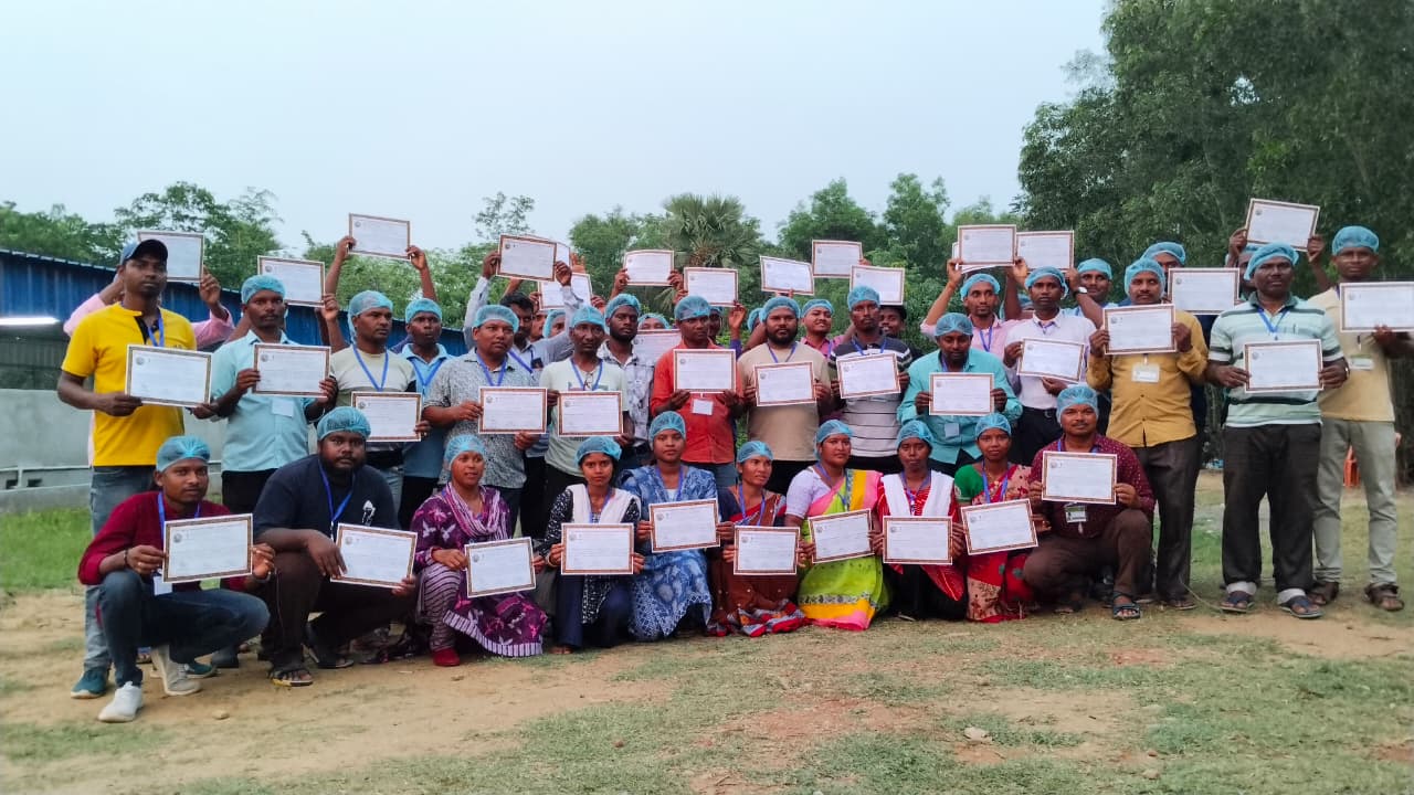 Group of farmers posing with certificates at farm