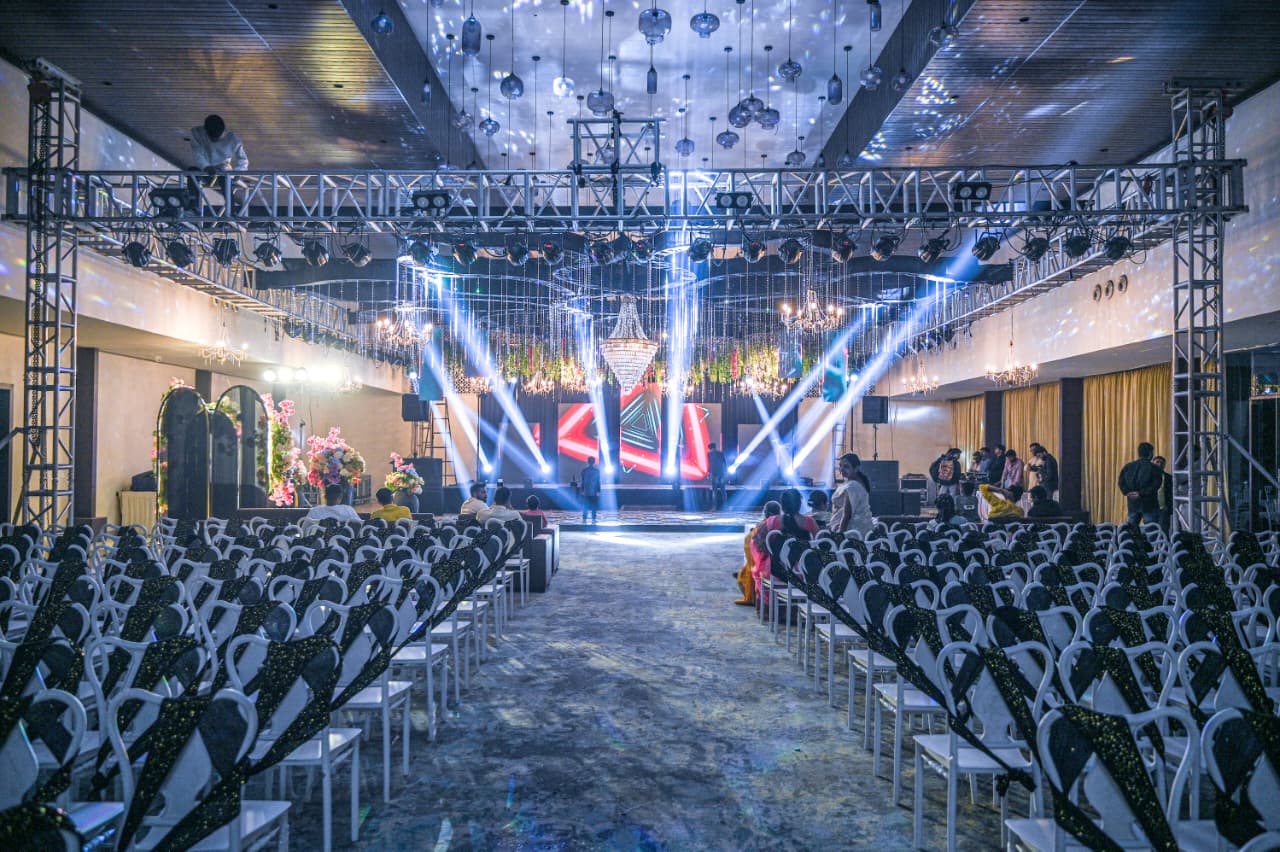 Best Banquet Hall in Nashik – Grand indoor hall with stage lighting and seating at Vrindavan Greens