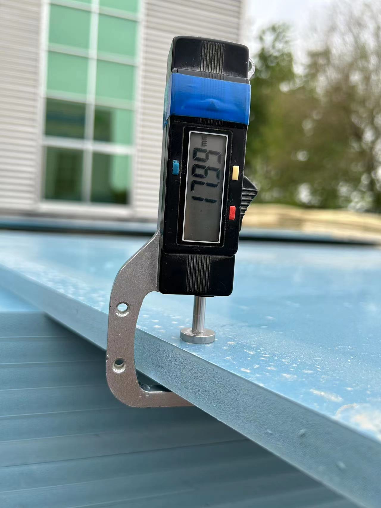 Digital caliper measuring PVC beam formwork panel thickness