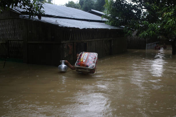 Person carrying supplies through flood