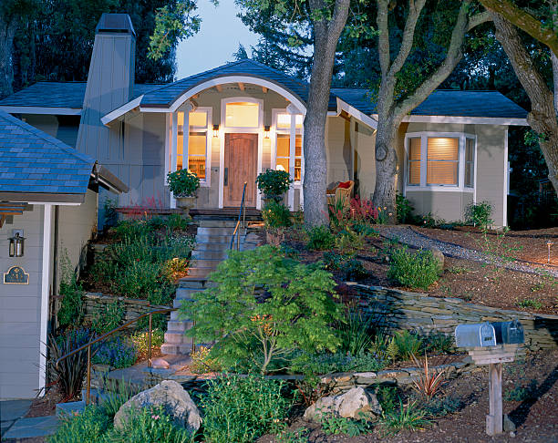 Beautiful residential property with attractive front yard landscaping, shrubs and autumn trees framing the entrance
