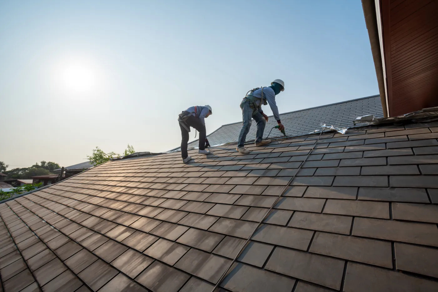 Roofworks Houston workers installing roof shingles