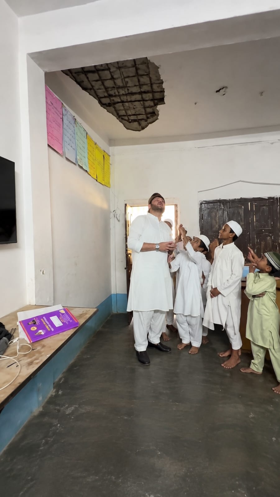 Damaged ceiling of madarsa with exposed rebar