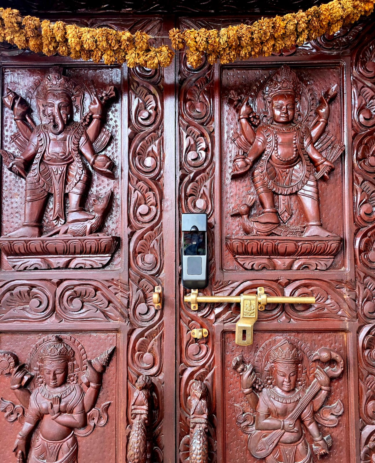 Lock on crafted wooden temple door