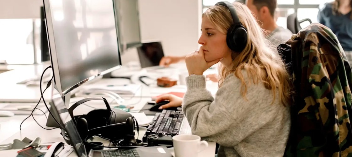 Professional analyst working at a computer in a modern office environment