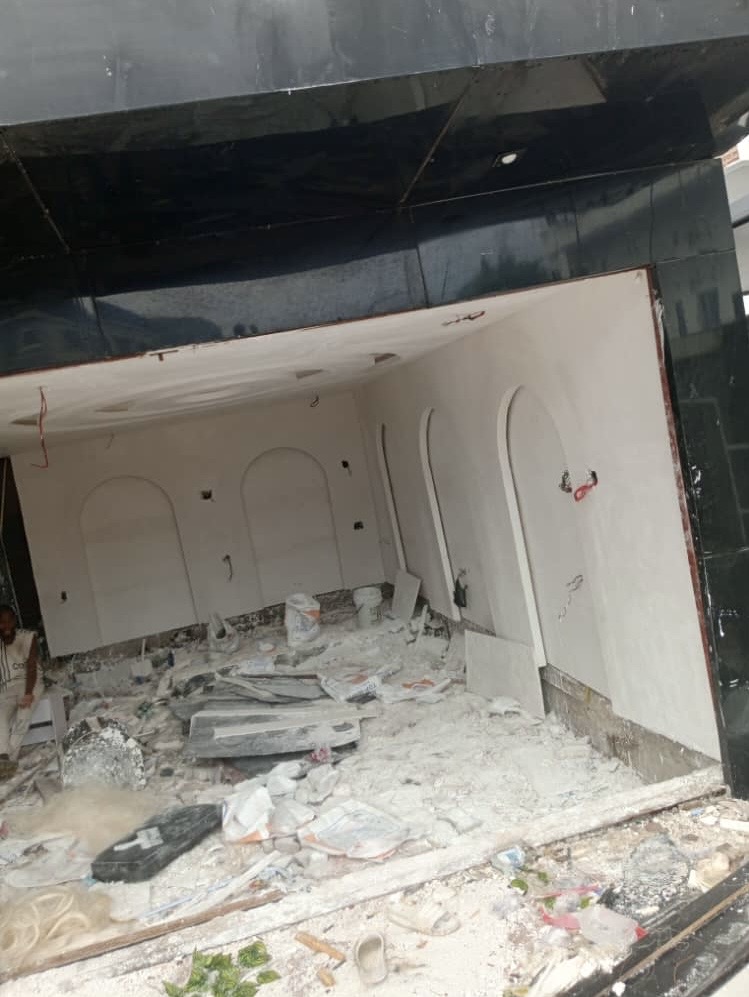 Before: Damaged interior with arched walls and rubble