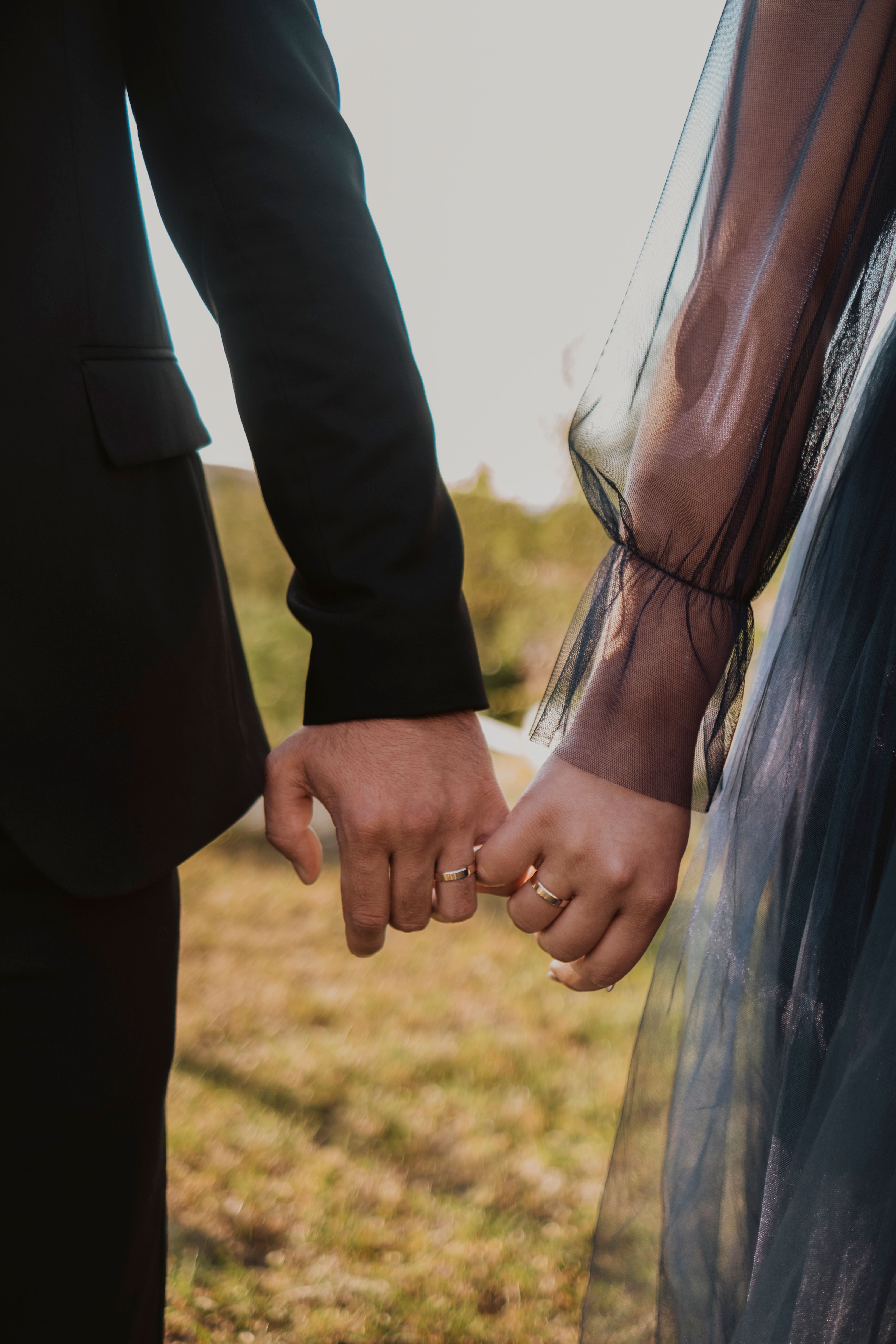 Close up holding hands with rings