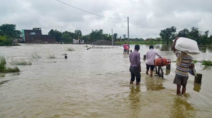 People wading through flood water