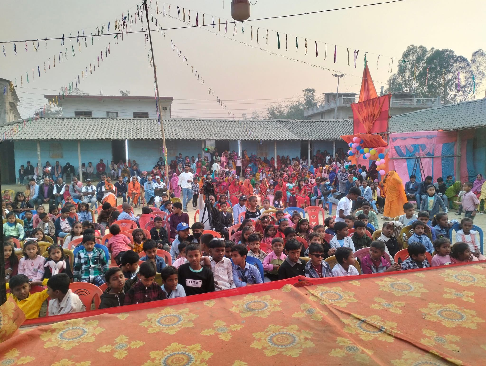 Outdoor community gathering with chairs and decorations