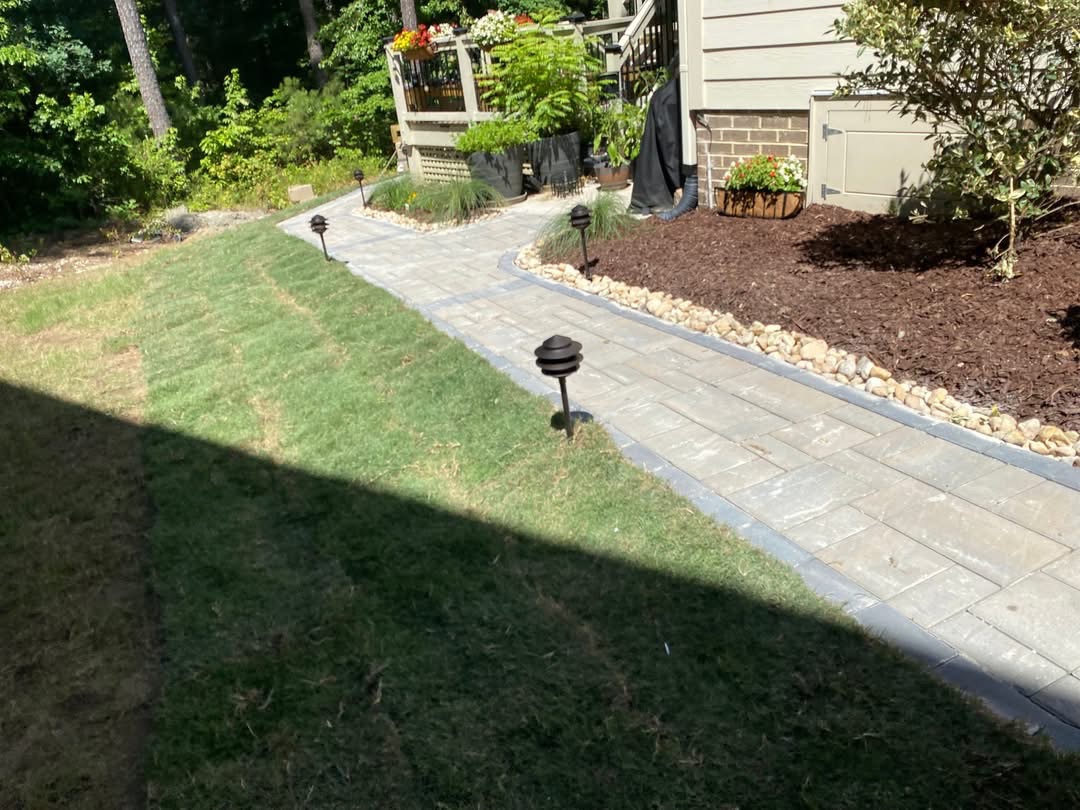 Stone pathway with landscape lighting by Beretta Five Solutions