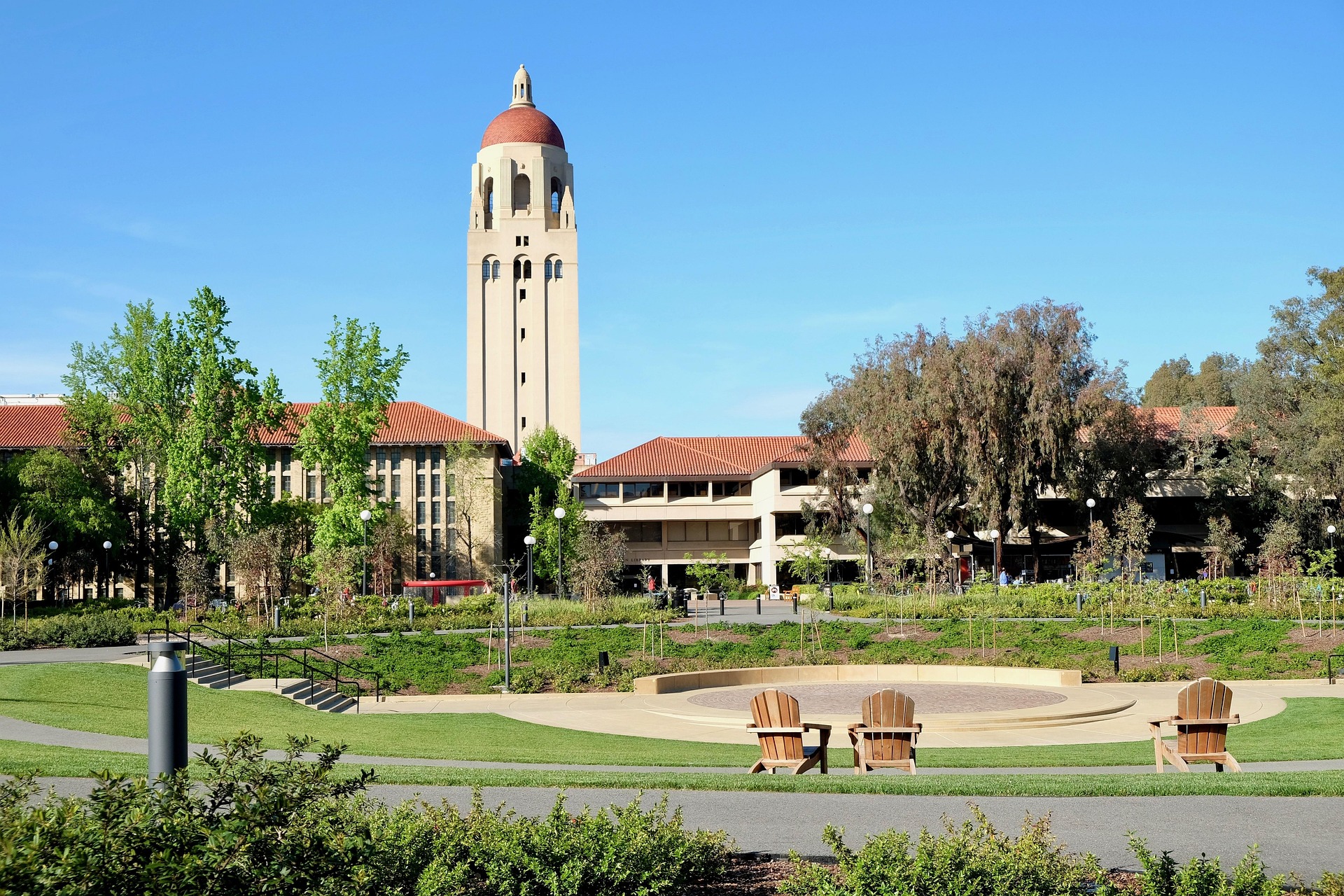 Corporate university campus with iconic red-domed tower surrounded by red-roofed buildings manicured lawns and lush trees for hedge maintenance program