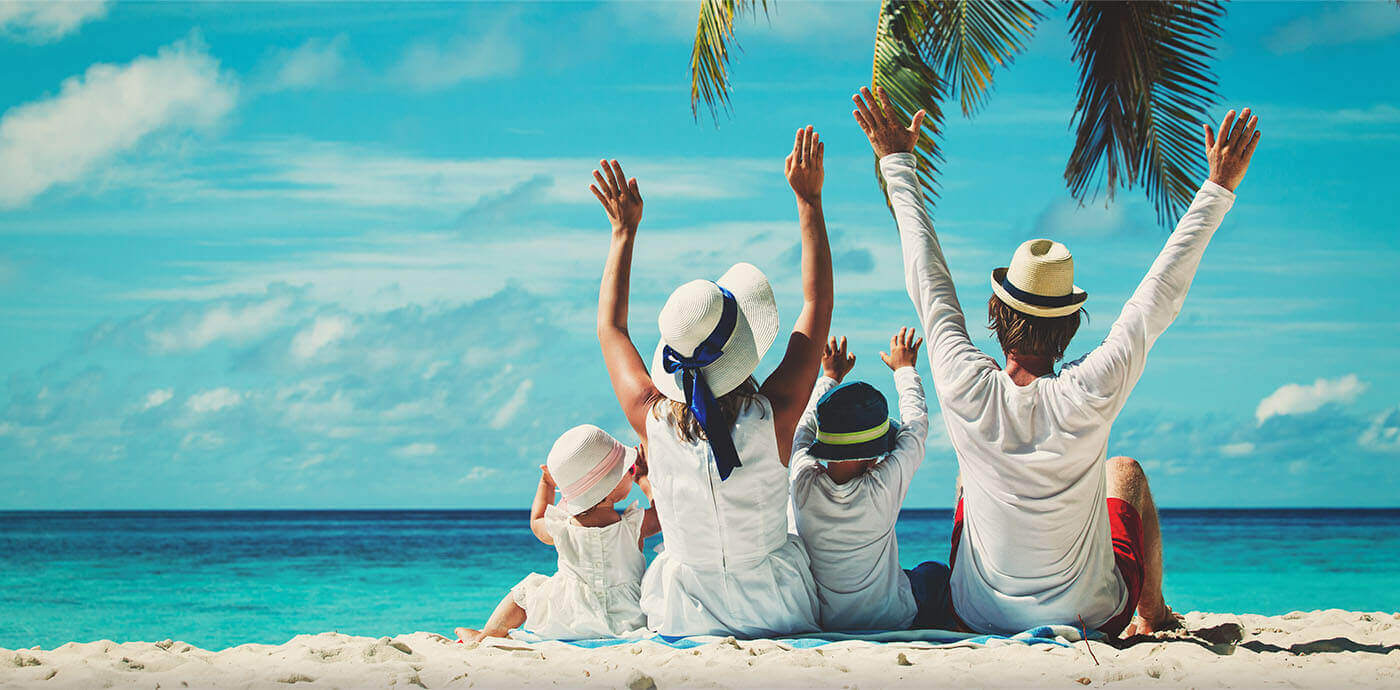 Happy family enjoying a beach vacation - Dream World Holidays