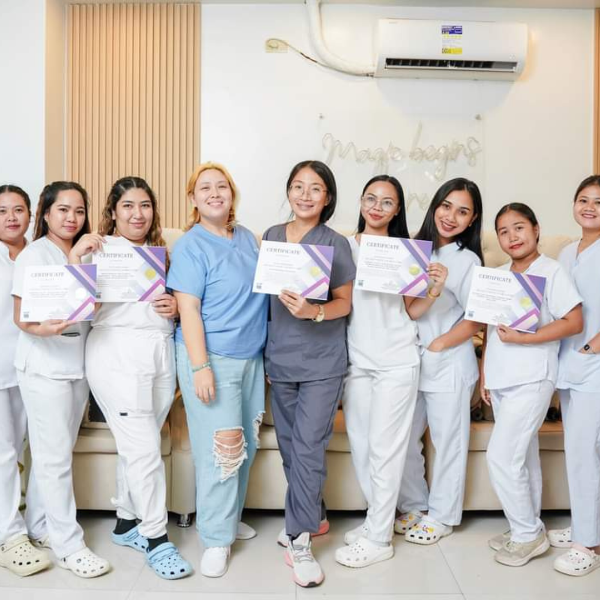 Certified aesthetic training graduates holding certificates