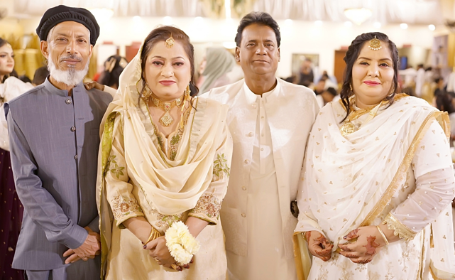 Bride and groom with family