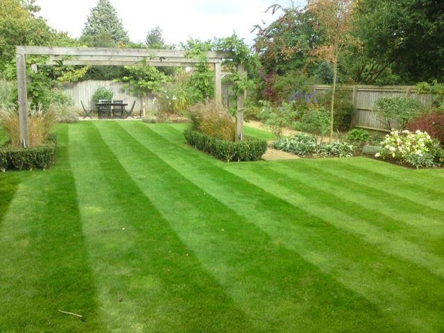 Landscaped striped lawn with gazebo
