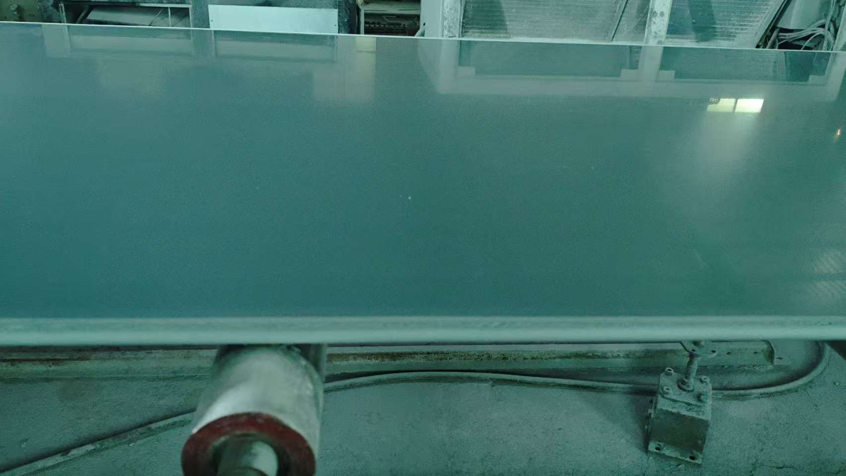 PVC sheet material being processed through flatbed handling equipment