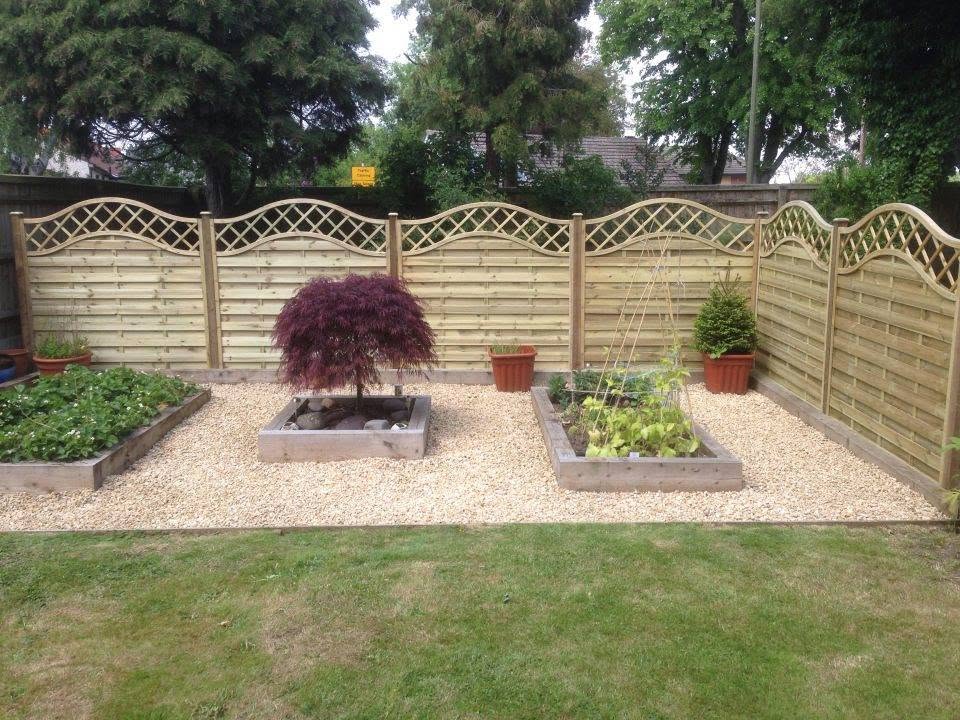 Garden with wooden planters and ornamental tree
