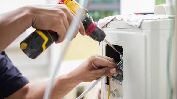 Elektriker bei der Reparatur eines Geräts