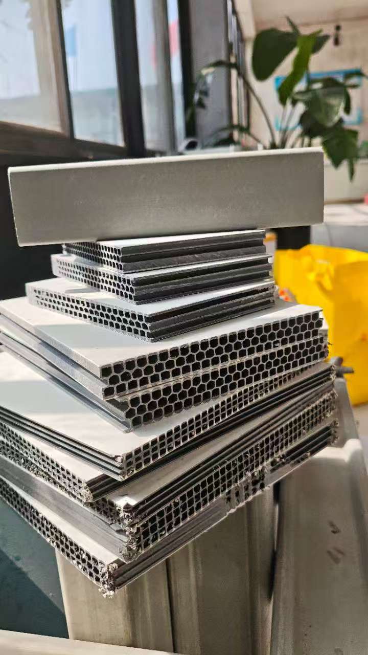 Stacked hollow plastic formwork panels showing hexagonal and rectangular hollow core structure in different sizes